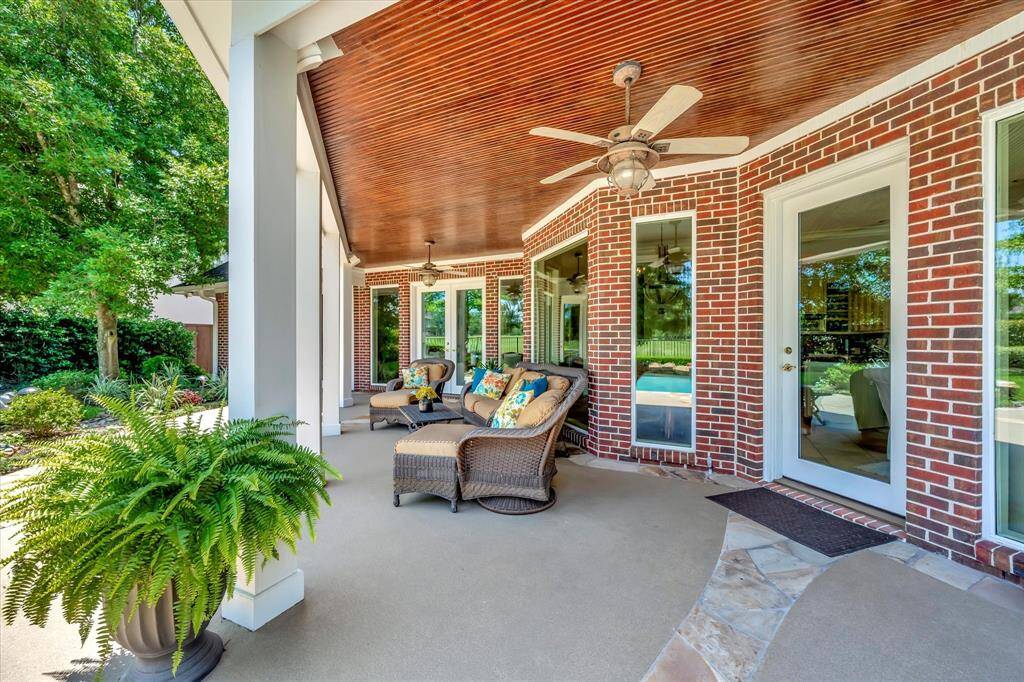 This spacious backyard features a lush green lawn, a private pool, and a covered patio with a built-in bar. Surrounded by mature trees and landscaped gardens, it's perfect for a game of crochet , horseshoes or cornhole.