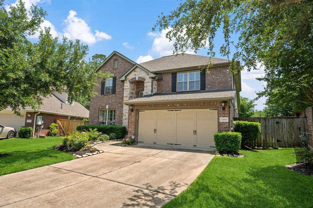 Charming two-story brick home with a well-maintained front yard and spacious driveway. Features a two-car garage and attractive landscaping, providing great curb appeal.