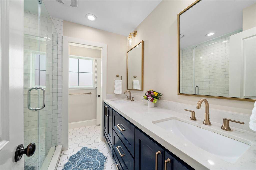 PRIMARY BATHROOM - Beautifully updated with dual sinks and a walk in shower! Private toilet area.