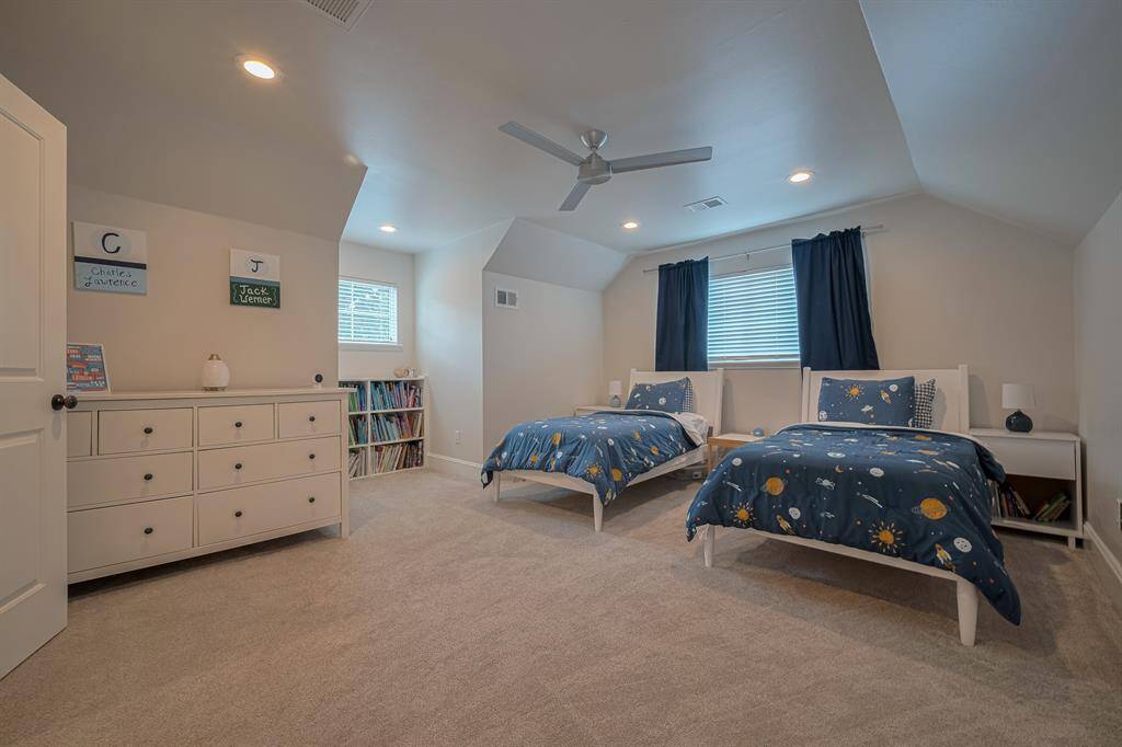 SECONDARY BEDROOM - Another GIANT bedroom with lush carpet and ceiling fans.