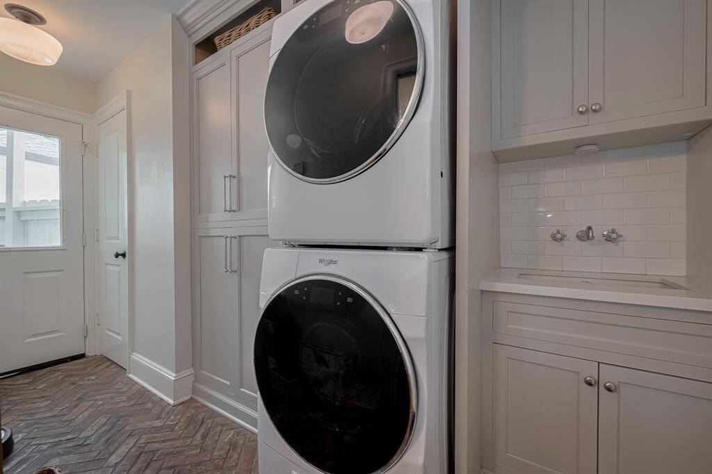 MUDROOM - Stackable washer and dryer, utility sink and tons of cabinetry for shoes, backpacks, etc! Powder bath is in the utility room.
