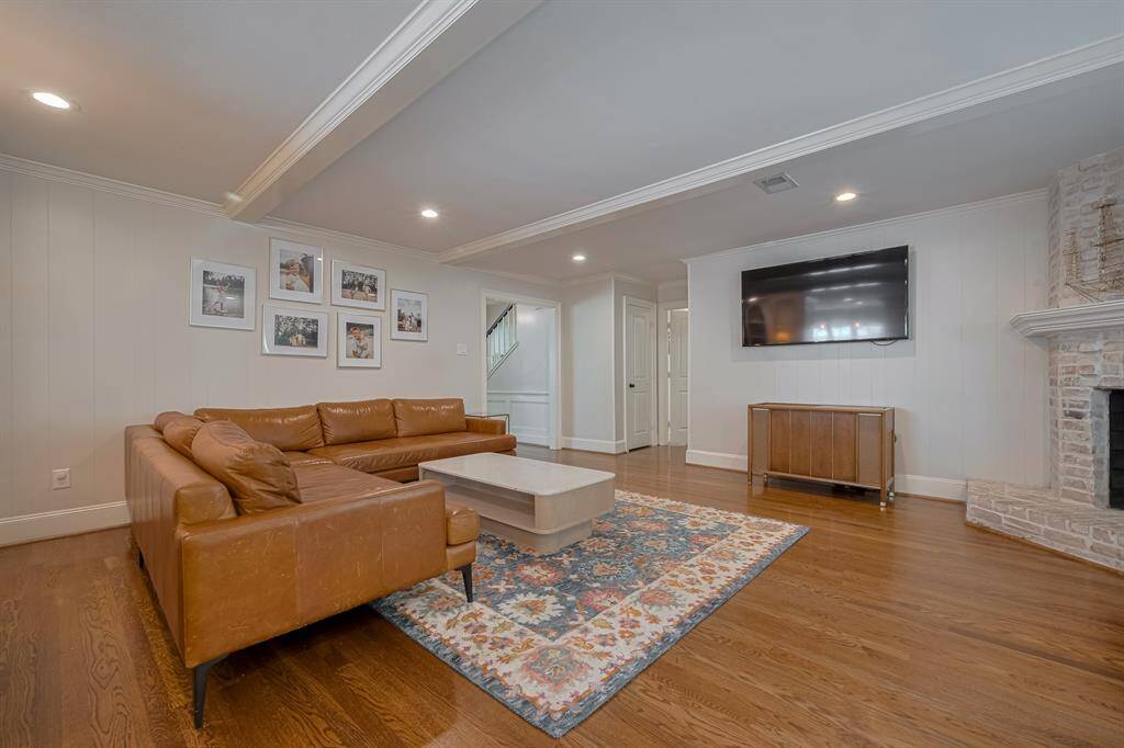 LIVING ROOM - The spacious living room is open to the kitchen and anchored by a beautiful brick fireplace.