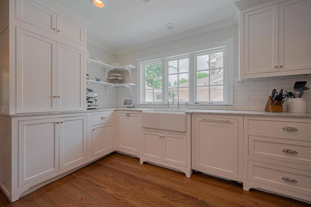 KITCHEN - Stunning white cabinets, modern hardware, beautiful countertops and a farmhouse sink.