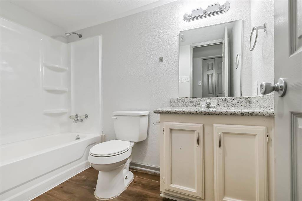 Hall bath has tub/shower surround and granite counter