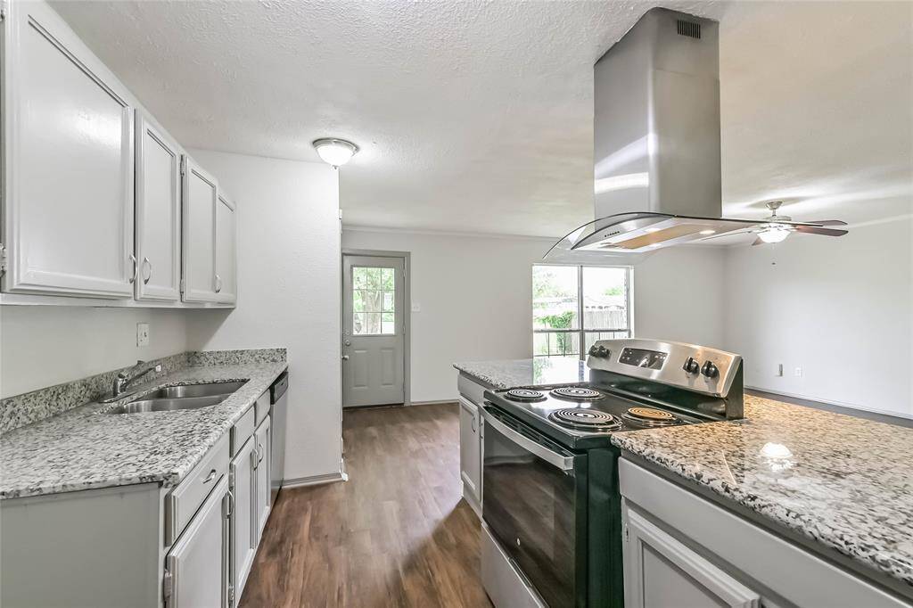 Kitchen has stainless appliances and granite counters