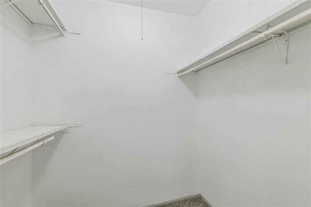 Primary bedroom walk in closet