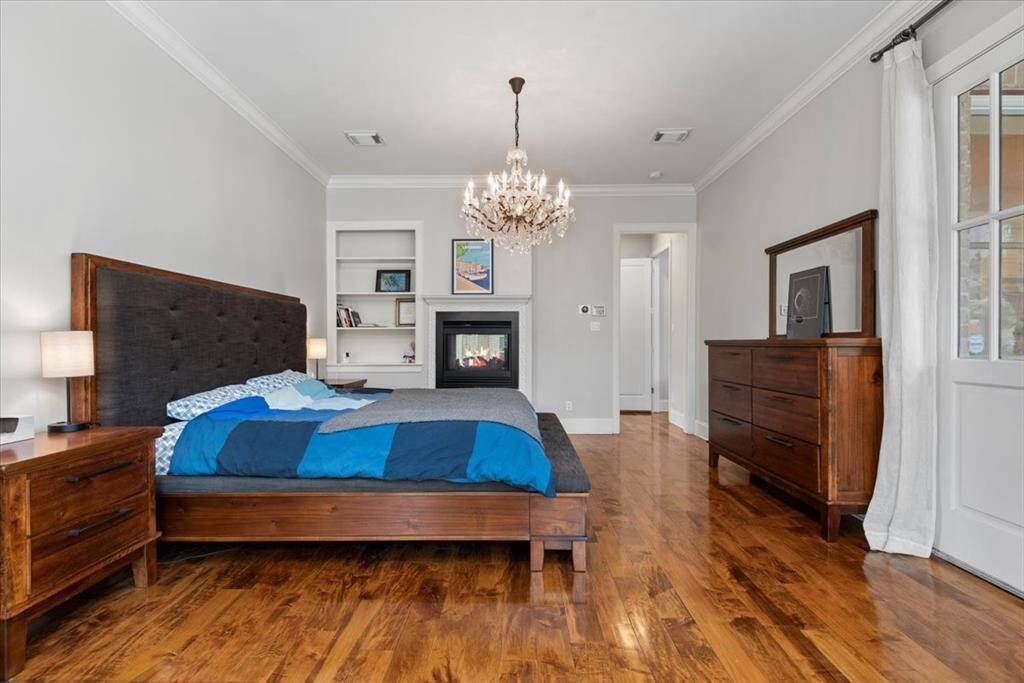 The large Primary En Suite features tall ceilings and beautiful hardwood flooring.