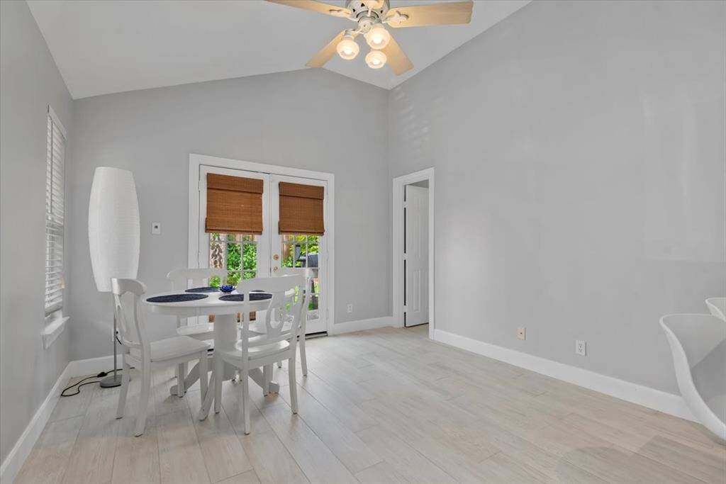 The ample sized guest house family room is large enough for a sitting and dining areas.  It features a vaulted ceiling and plenty of natural light.