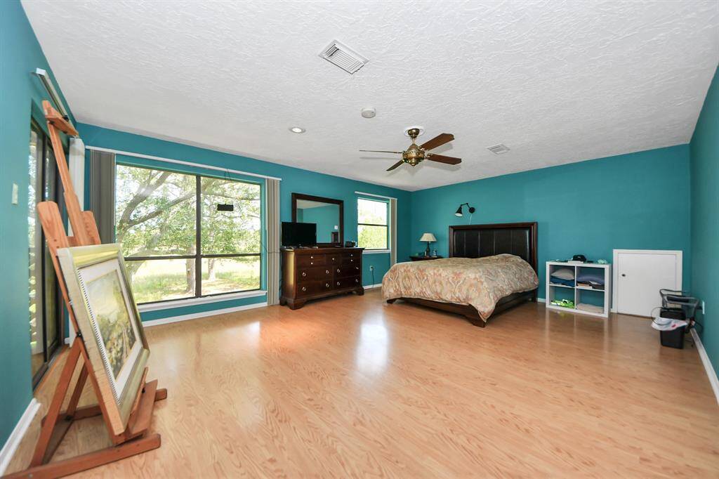 The primary bedroom in this house is amazing! It's huge with enough space for a big seating area.