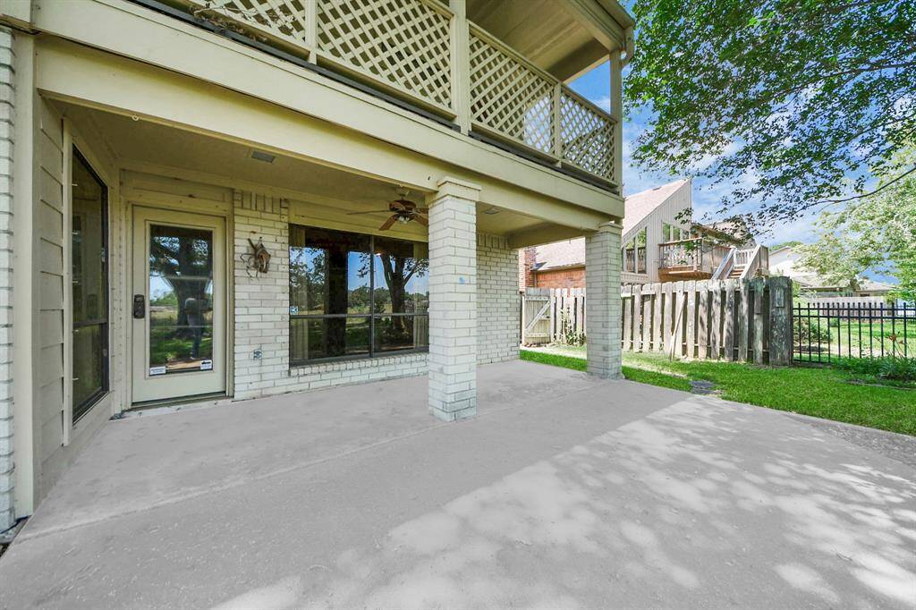 This gorgeous home has a backyard with a covered patio that gives you the best view of the green space.