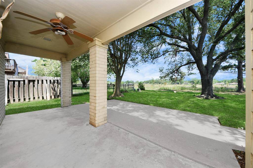 This gorgeous home has a backyard with a covered patio that gives you the best view of the green space.