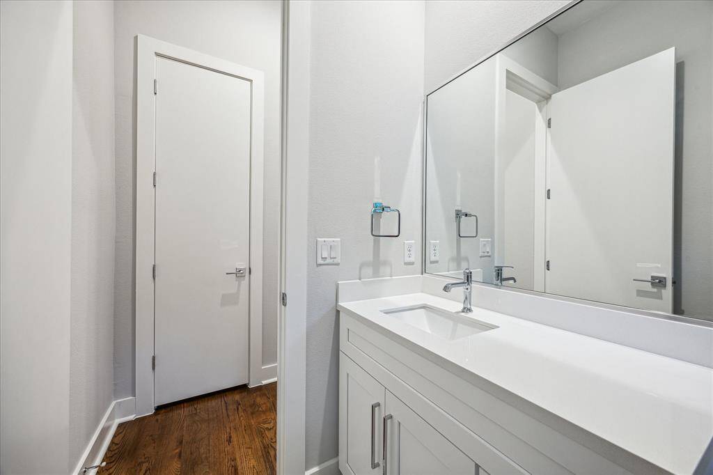 Sophisticated design meets functionality in this half bath, showcasing modern fixtures and a clean vanity with ample countertop space. The neutral palette and understated elegance make this a refined space for guests.