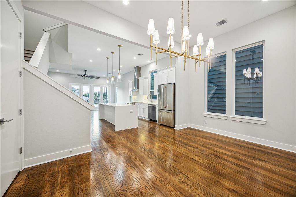 From chandelier elegance to the seamless flow into the chef-inspired kitchen, this space is designed for entertaining. Tall ceilings and natural light amplify the open layout, blending formal dining with everyday comfort.
