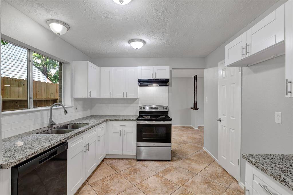 A wider view of the kitchen highlights its layout, giving you a clear sense of the available workspace.