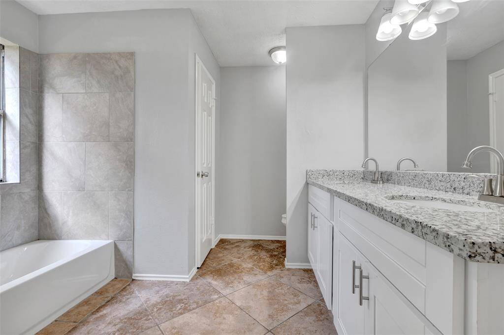 Inside the main bathroom, you'll find granite countertops, a tub and shower combination, double sinks, and walk-in closets, all designed for everyday comfort and convenience.