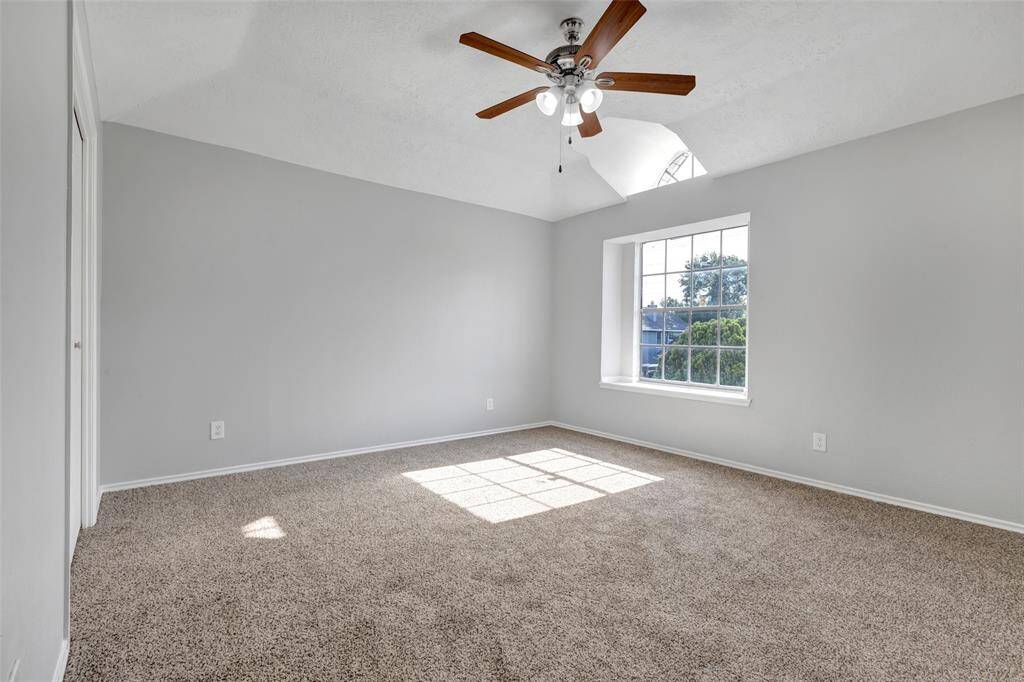 This is one of the three secondary bedrooms located on the second floor. It features carpeted flooring and includes an window facing the front lawn.