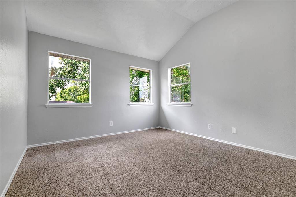The last bedroom on the second floor sits at the end of the hallway. It features carpeted flooring and plenty of natural light. This empty room offers a flexible space you can set up to suit your needs.
