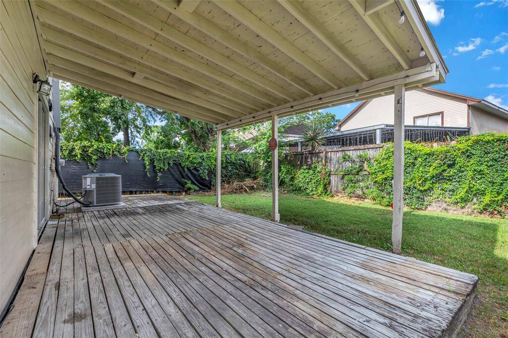 View of the back of the house shows a covered patio area, which offers potential for updates or customization to fit your outdoor plans.