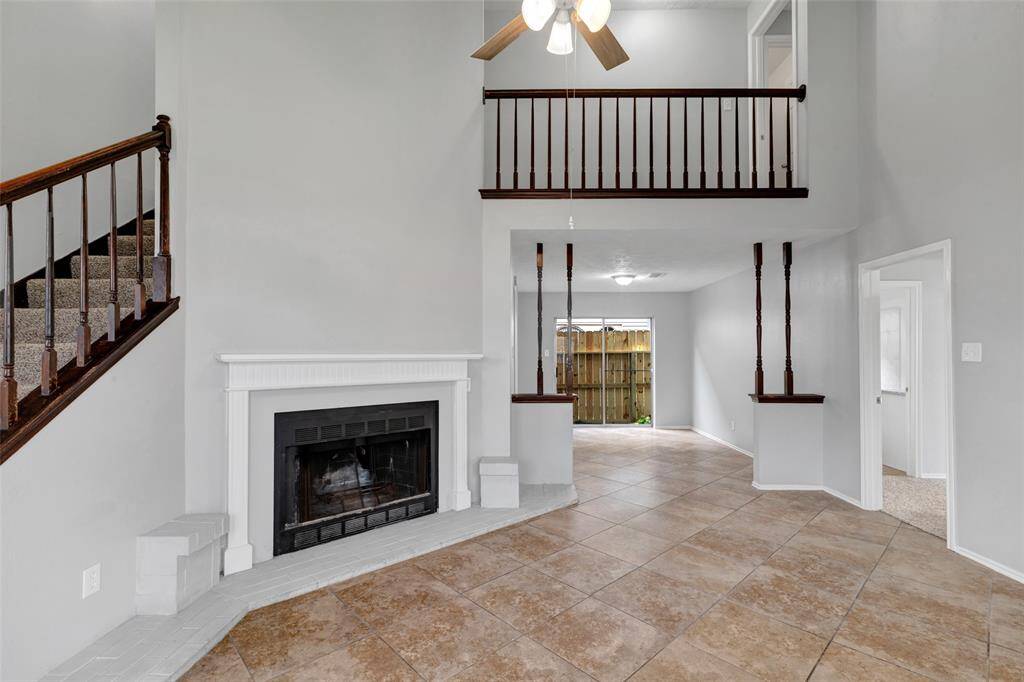 This additional view of the living room offers a glimpse of the dining area and the door that leads to the main bedroom, highlighting the home's open and connected layout.