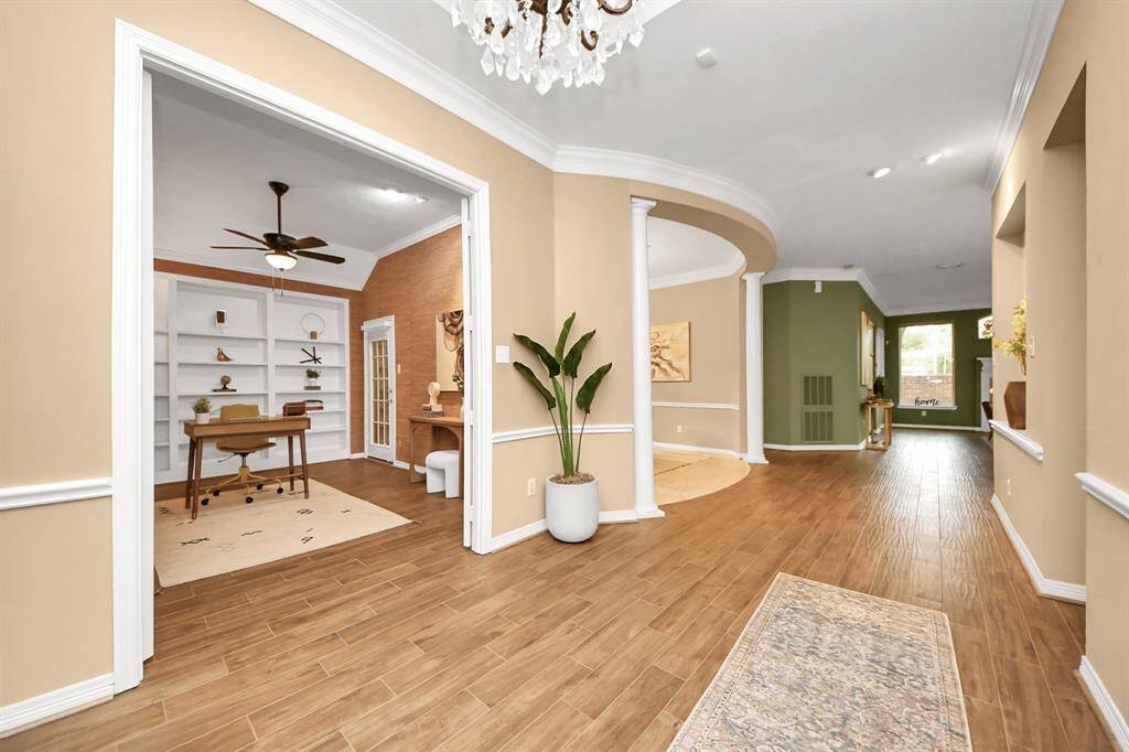 Welcome to 1542 Orchard Park Dr! As you walk into the home, you’ll immediately notice the elegance of the crown molding and the spacious open layout that leads into the living area. To the left, you'll find a beautiful office with French doors, offering a perfect space for work.