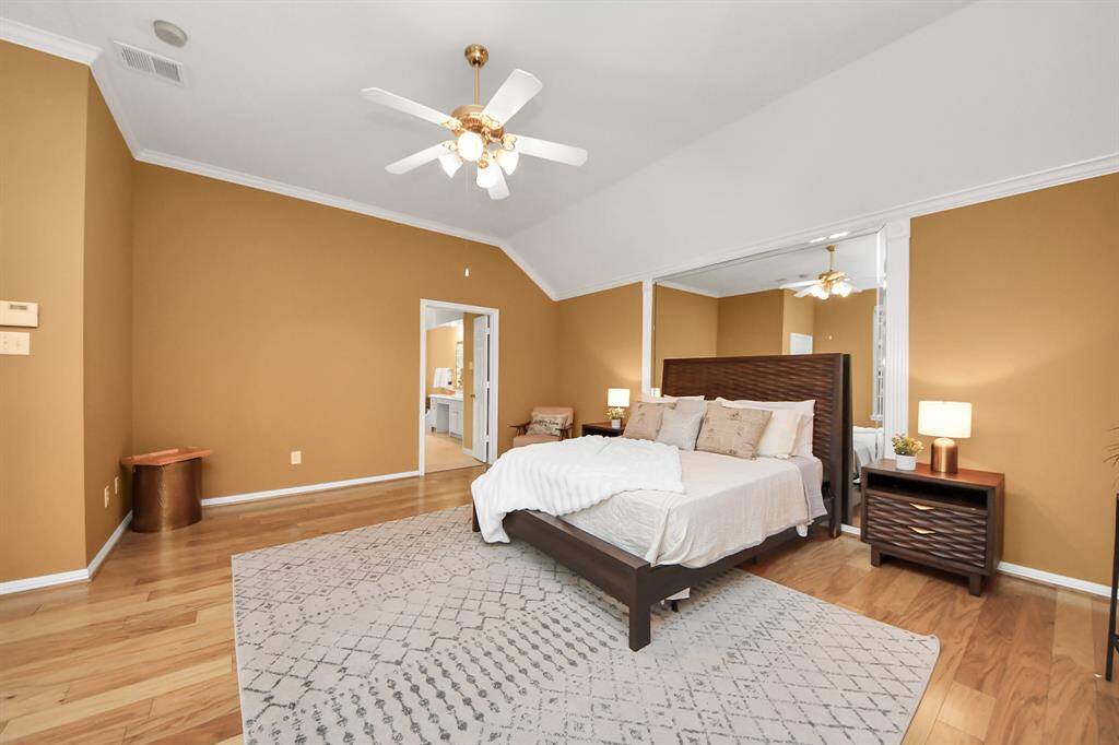 This is the primary bedroom—spacious, with high ceilings and crown molding throughout, adding a touch of elegance to the space.