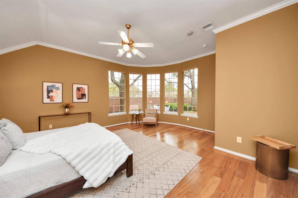 You can see how much room there is for a seating area and even space for a desk to the right, where the small table is located. And, as you might have guessed, there are plenty of windows bringing in natural light and offering a lovely view of the backyard.