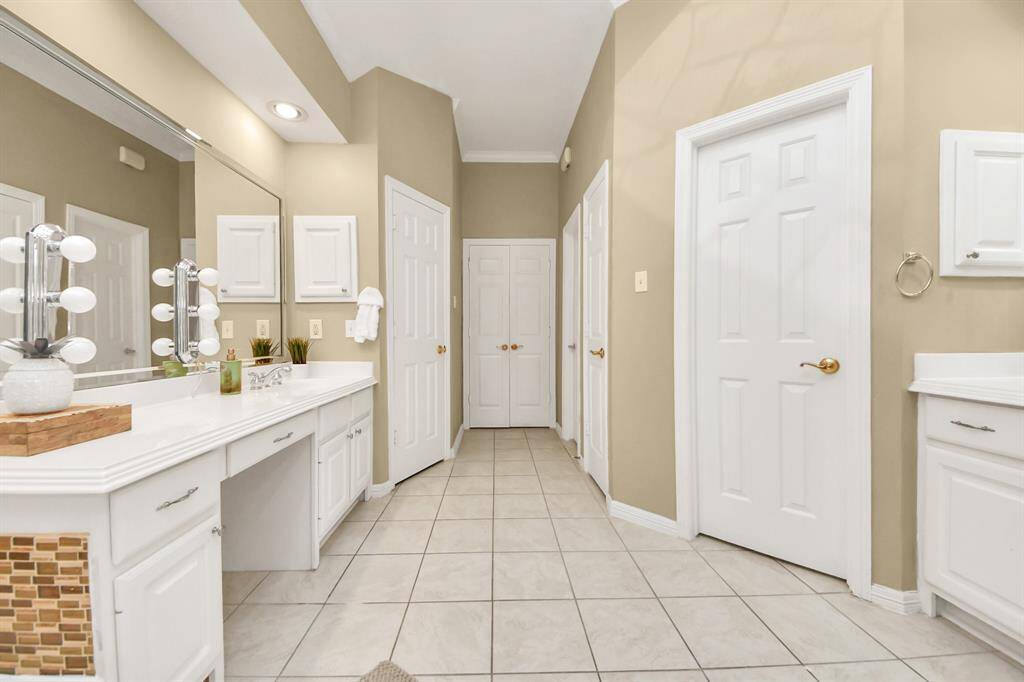 From this view, you can see the two doors on the left that lead to separate walk-in closets. The third door on the right is a linen closet, and just to the left of that, you’ll find the door to the toilet area for added privacy.