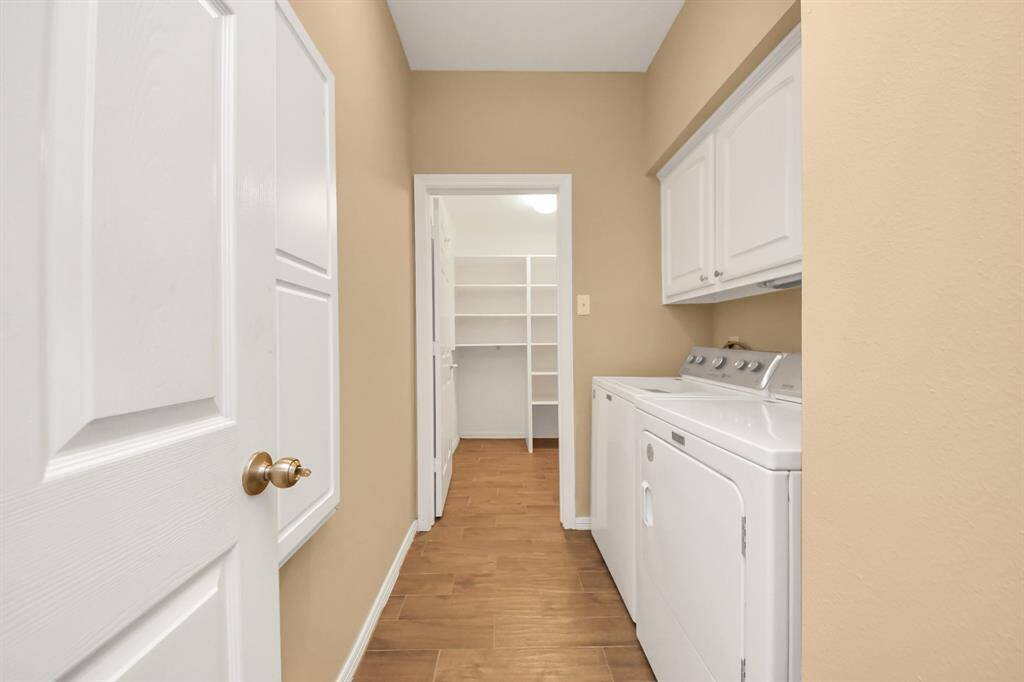 This is the laundry room, conveniently located near the entrance of the house, right between the garage and the study. The washer and dryer were replaced in 2023 and convey with the home. At the end of the room, there’s a spacious closet area for extra storage.