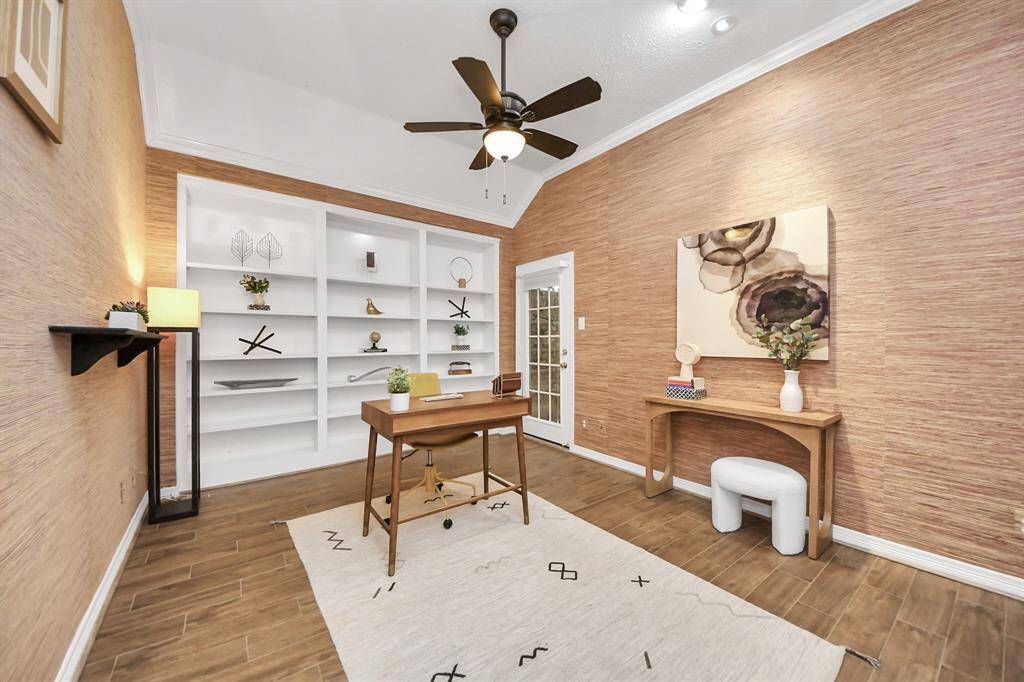 The office has high ceilings, crown molding, and built-in bookshelves, giving it a stylish and functional feel. It’s spacious enough to fit a sofa, making it a great spot to work or relax. The door at the end opens to a small atrium, adding a nice touch of natural light.