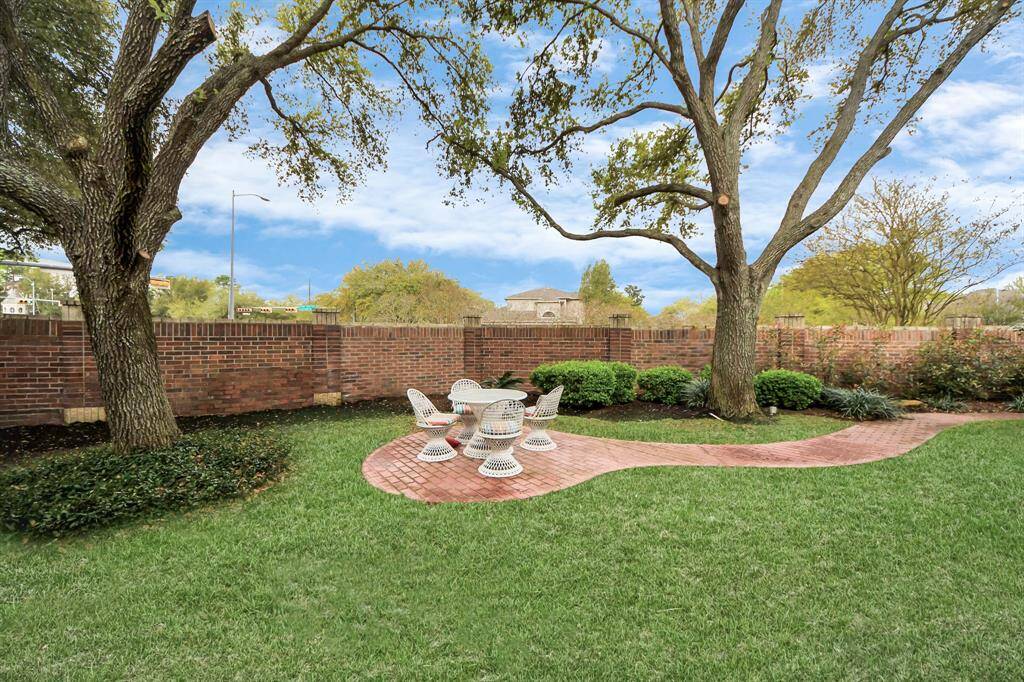 This is another section of the backyard, featuring a paved area perfect for setting up an outdoor seating area. The yard is spacious enough to build your own pool, giving you endless possibilities to customize your outdoor space!