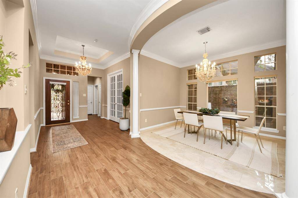 This shot is taken from the living room area—just look at how elegant this space is! The crown molding and wide hallway add a touch of sophistication and an open, airy feel.