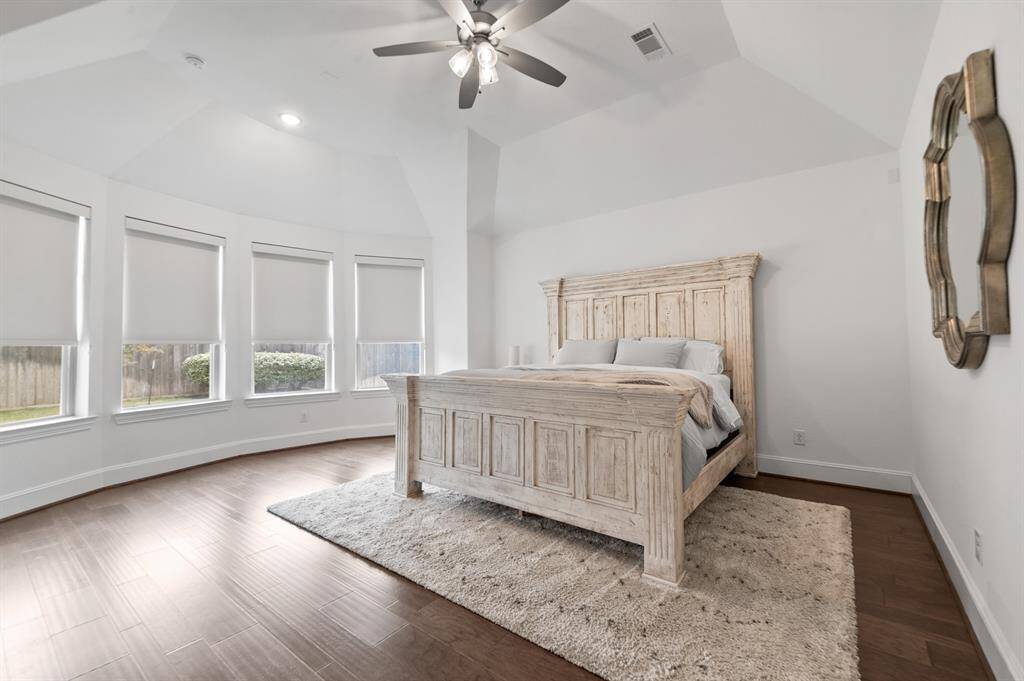 Spacious primary bedroom with serene ambiance, large windows, and elegant design for ultimate comfort and relaxation