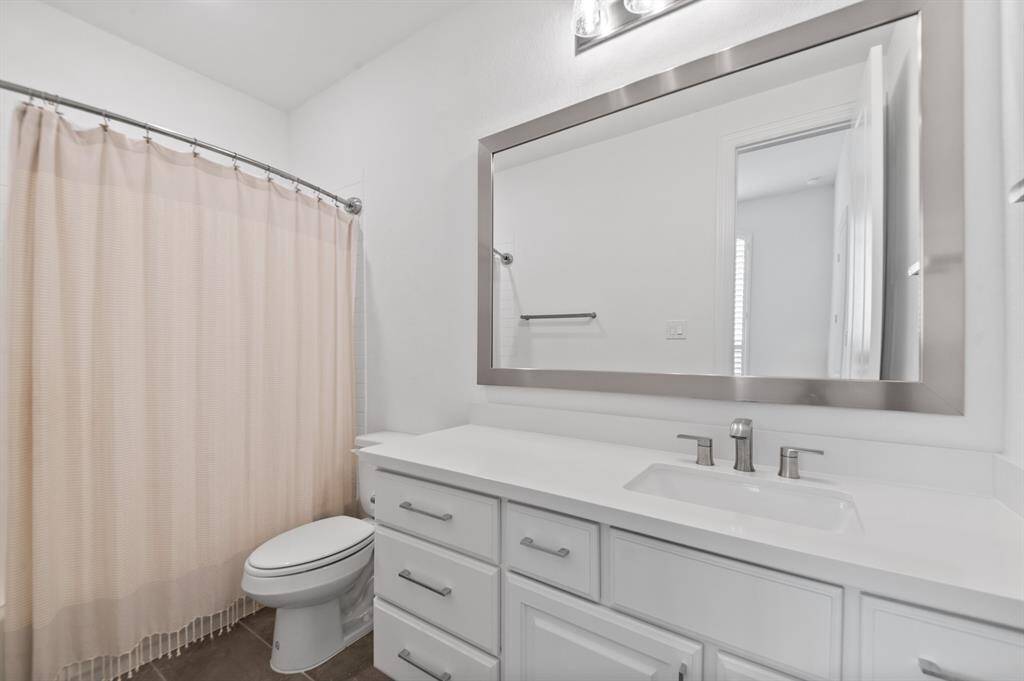 Private ensuite bathroom, featuring stylish finishes and a functional layout, providing a serene retreat just off the bedroom