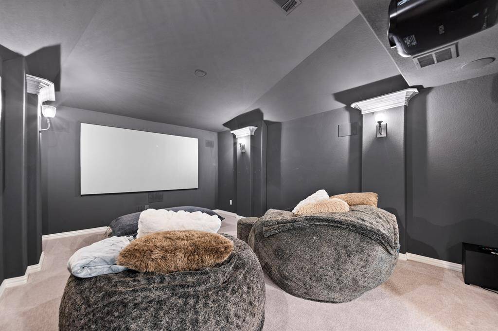 Dedicated theater designed for the ultimate viewing experience, featuring built-in surround sound, a high-quality projector, and a expansive 110-inch screen.