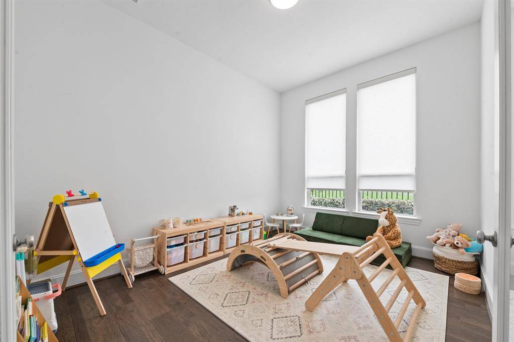 Elegant home office with French doors just off the grand entry, featuring ample natural light and a refined atmosphere perfect for productivity.