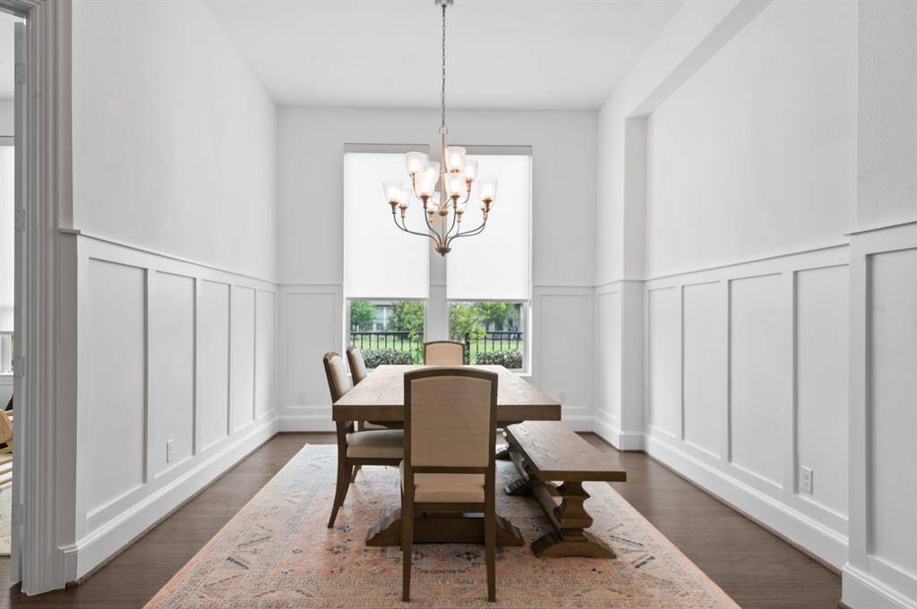 Elegant dining area off the entryway, offering a refined space for gatherings with stylish lighting and an open yet intimate feel