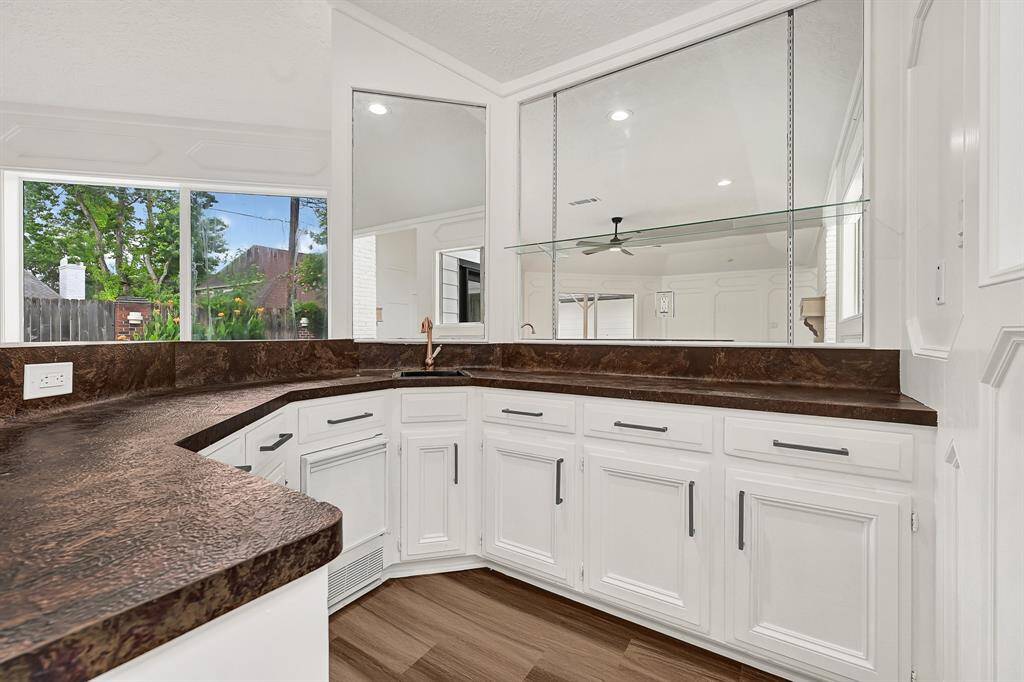 Wraparound wet bar with granite countertops and views into the living space.