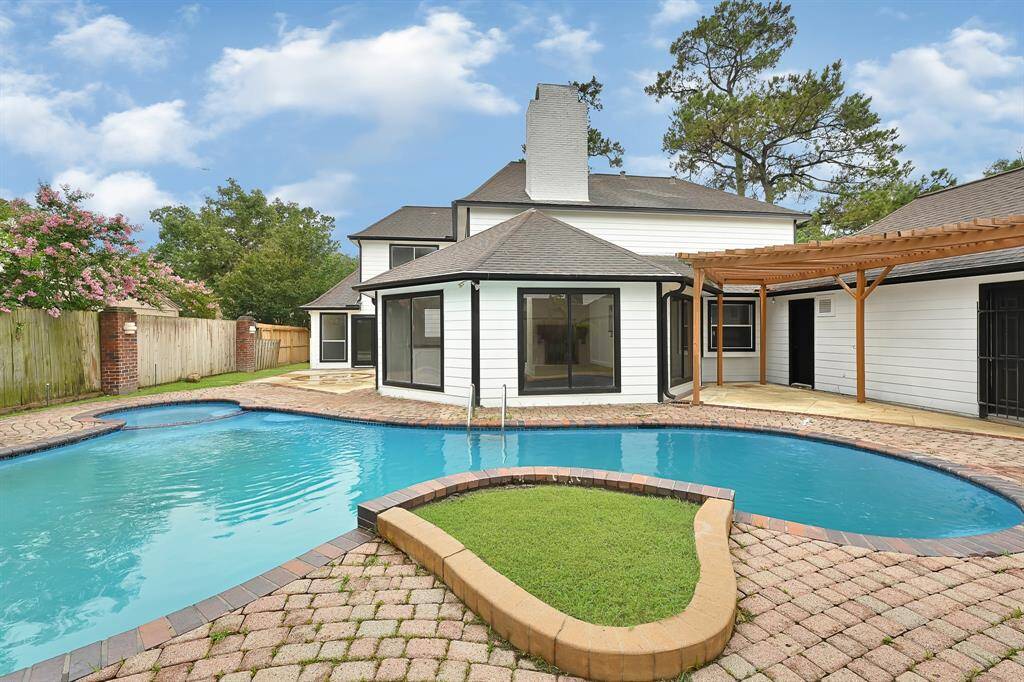 Backyard retreat featuring a custom pool, spa, and putting green.