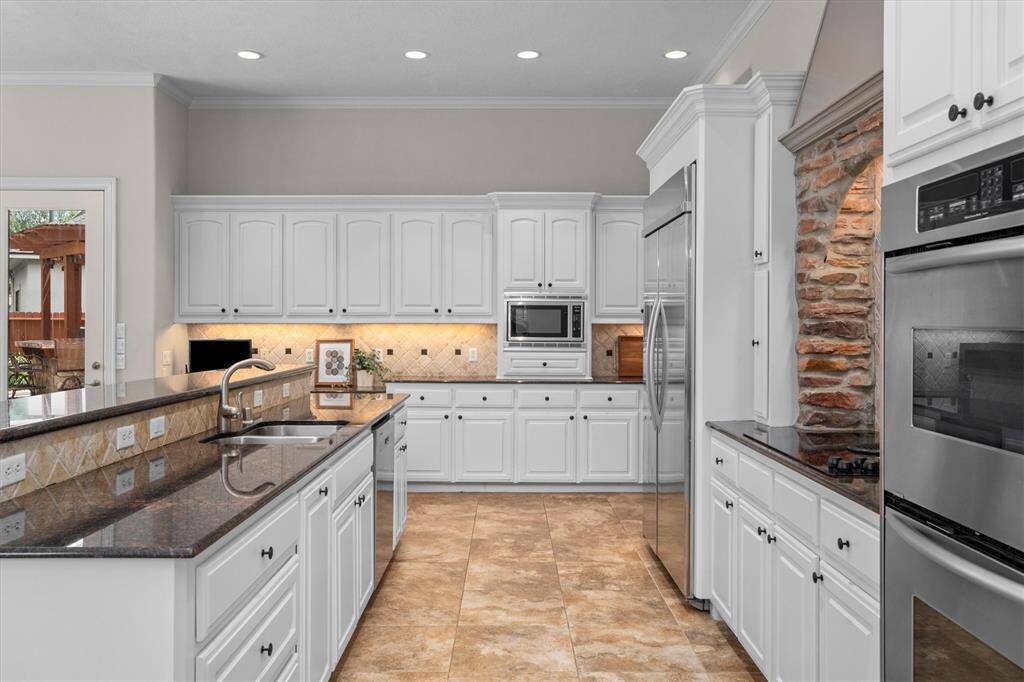 The kitchen island is expansive with granite counters