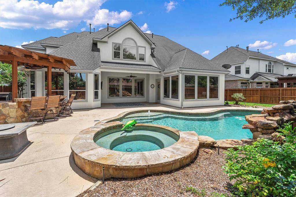 backyard with heated pool and spa