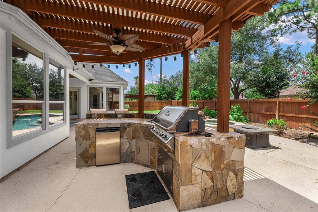 Outdoor kitchen with large bar for entertaining
