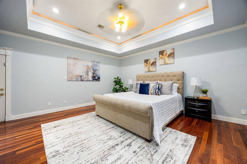 The primary bedroom is thoughtfully located downstairs, offering both privacy and convenience. Private access to the courtyard allows for quiet mornings or relaxing evenings outdoors.
