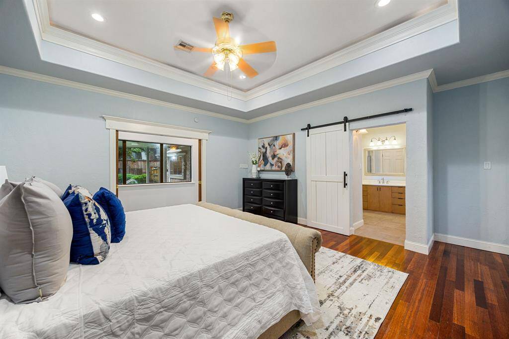 Large windows frame serene views of the backyard and pool, filling the room with natural light.