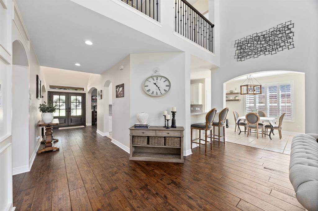 A look towards the double front doors and cat-walk across the second floor.