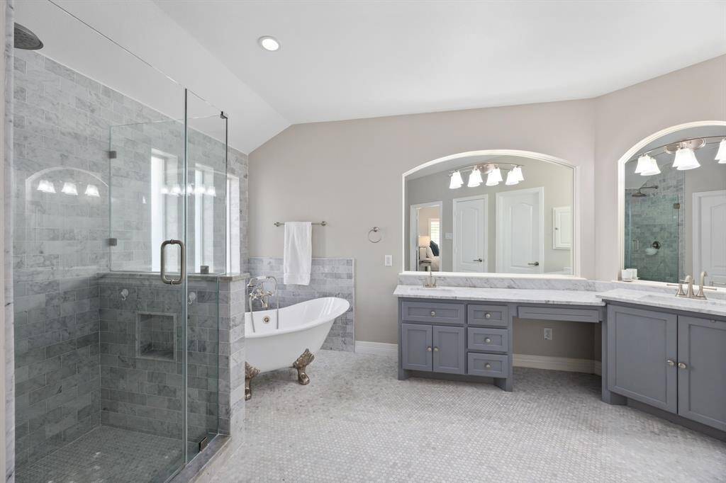Completely remodeled from head-to-toe, the marble-drenched primary bathroom is the ultimate retreat.