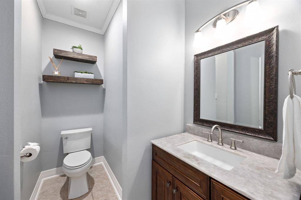 Downstairs half bath with Taj Mahal quartzite counters.