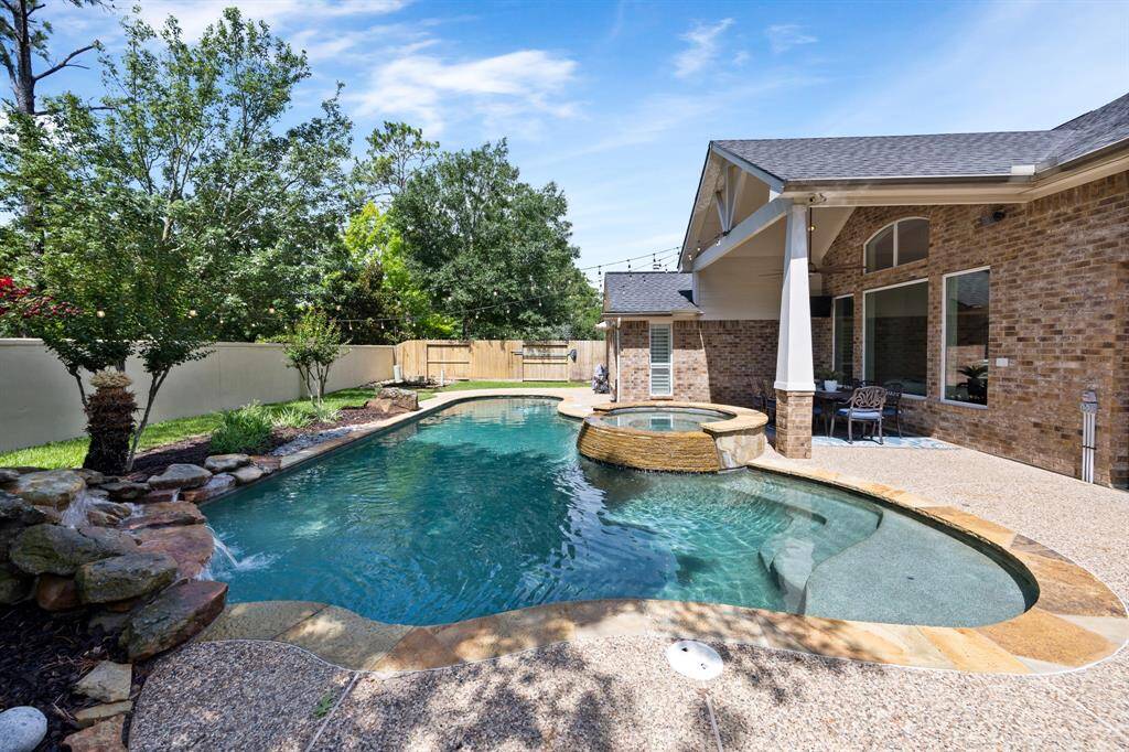 Gorgeous pool and waterfall with raised spa.