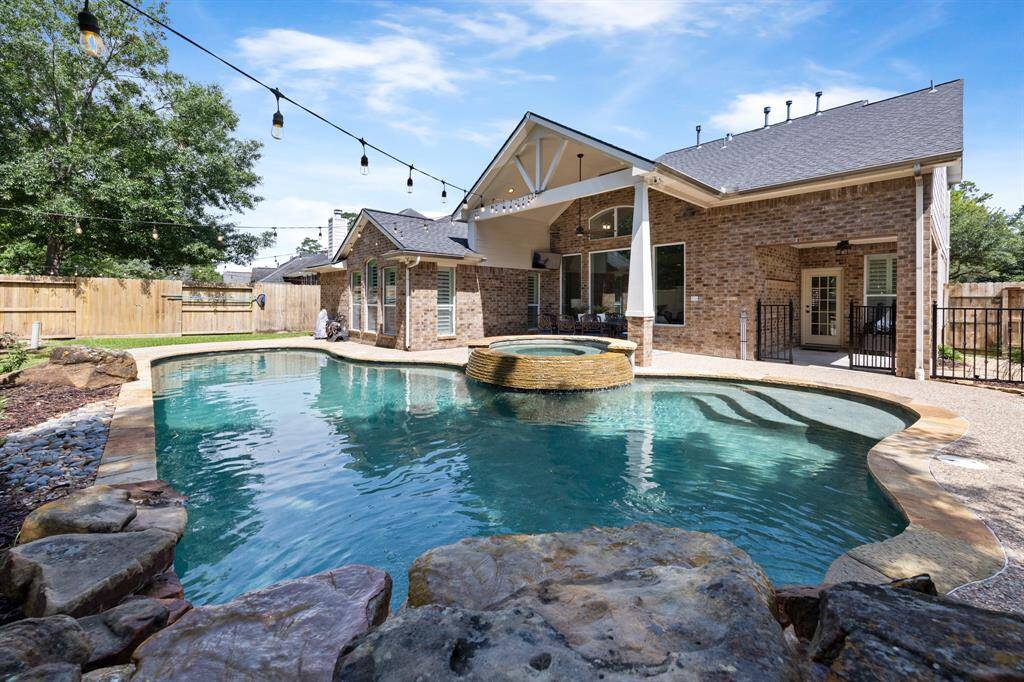 Secondary porch is located right off the back door, which is perfect for grilling or kiddos to play safely behind the gate.