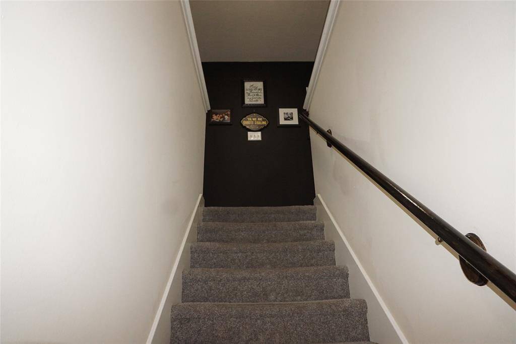 Staircase leading upstairs to 3 spacious bedrooms, 2 baths and utility room.
