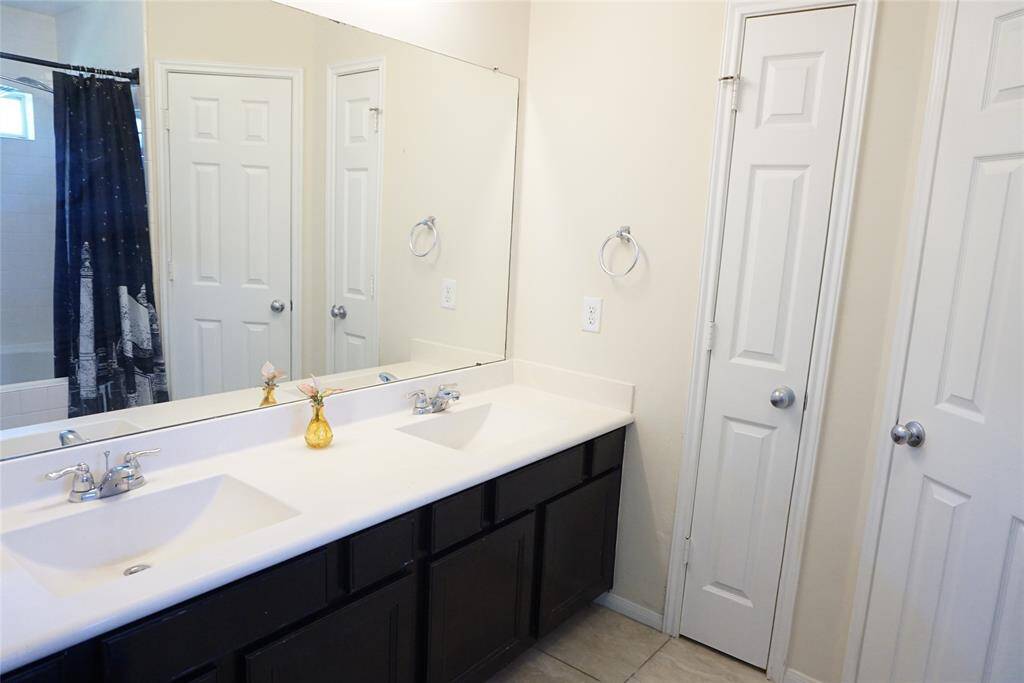 Primary Bath with double sinks AND a linen closet for more storage!